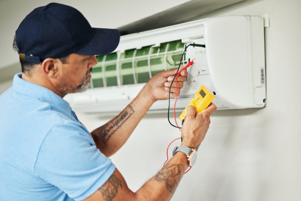Technician testing a ductless mini-split with a multimeter, mini-split repair in Everett