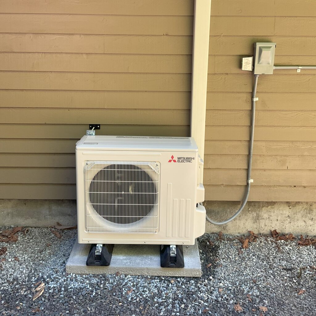 Mitsubishi mini-split outdoor unit on a pad, mini-split repair in Everett